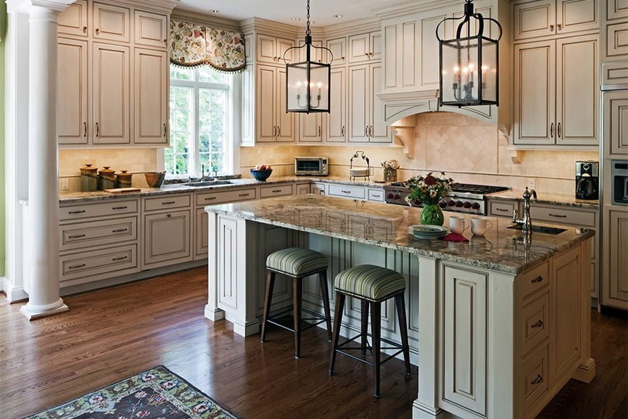 Transitional kitchen and island with tan cabinetry, granite countertops, and medium hardwood flooring