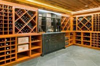 Custom built in-home wine cellar with floor-to-ceiling cabinetry and a wood paneled ceiling