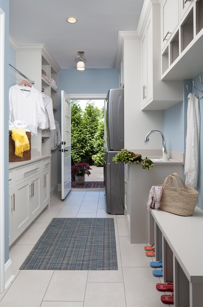 Transitional mudroom with white cabinetry, white tile flooring, and light blue wall color
