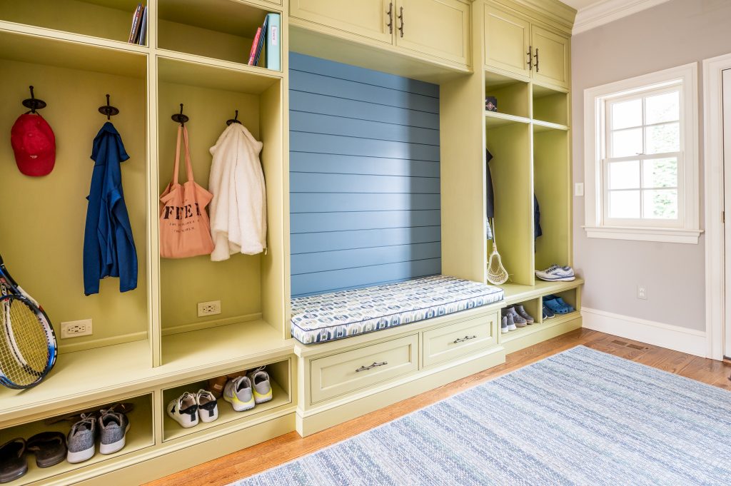 Transitional yellow mudroom cubbies with blue backsplash bench
