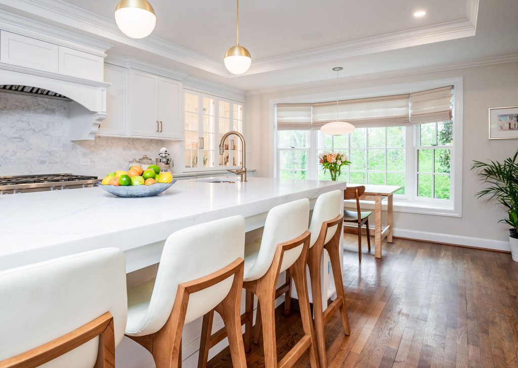 Transitional kitchen island with white marble countertops, orbed flood lights, and high sink (More chairs)