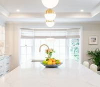 Transitional kitchen with stainless steel oven, white cabinetry, marble countertops (Different view)