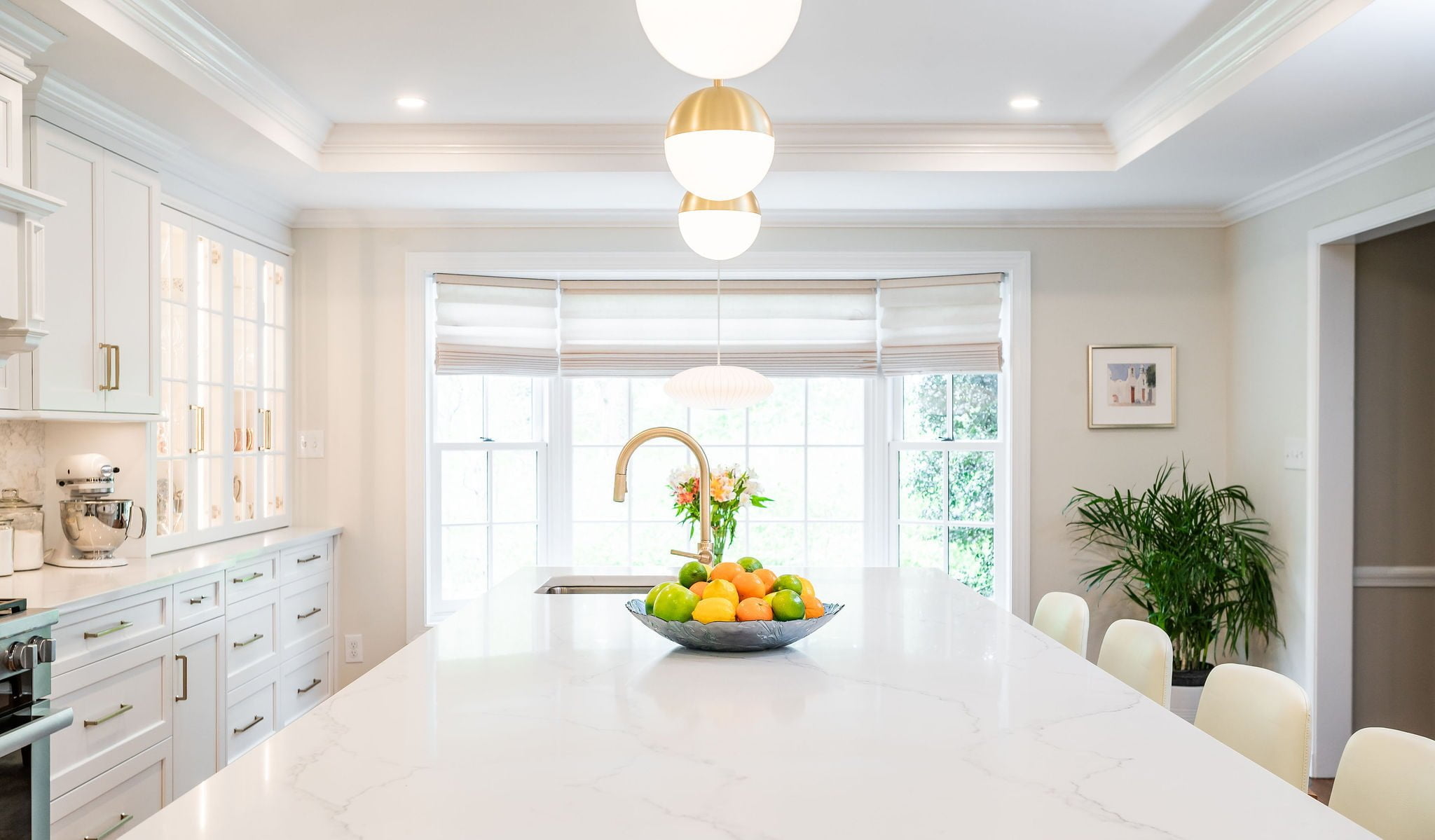 Transitional kitchen with stainless steel oven, white cabinetry, marble countertops (Different view)