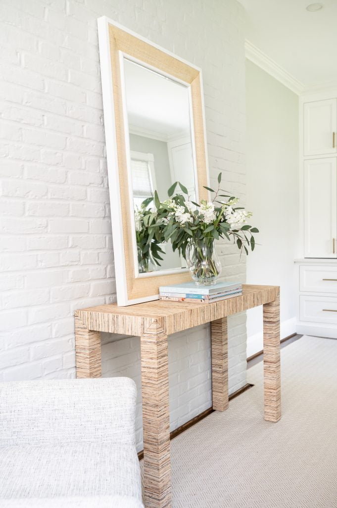 Home office decor, wooden table with large mirror, white painted brick wall