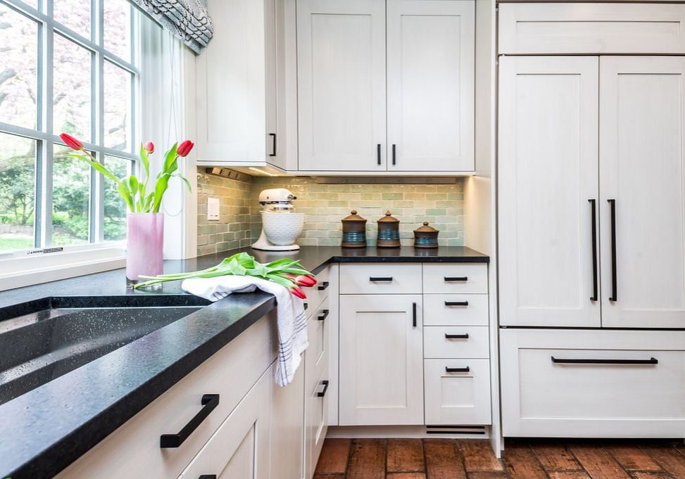 Transitional custom white cabinetry and decor for refrigerator, with brown terra-cotta tile flooring and light green tile backsplash (Other view)