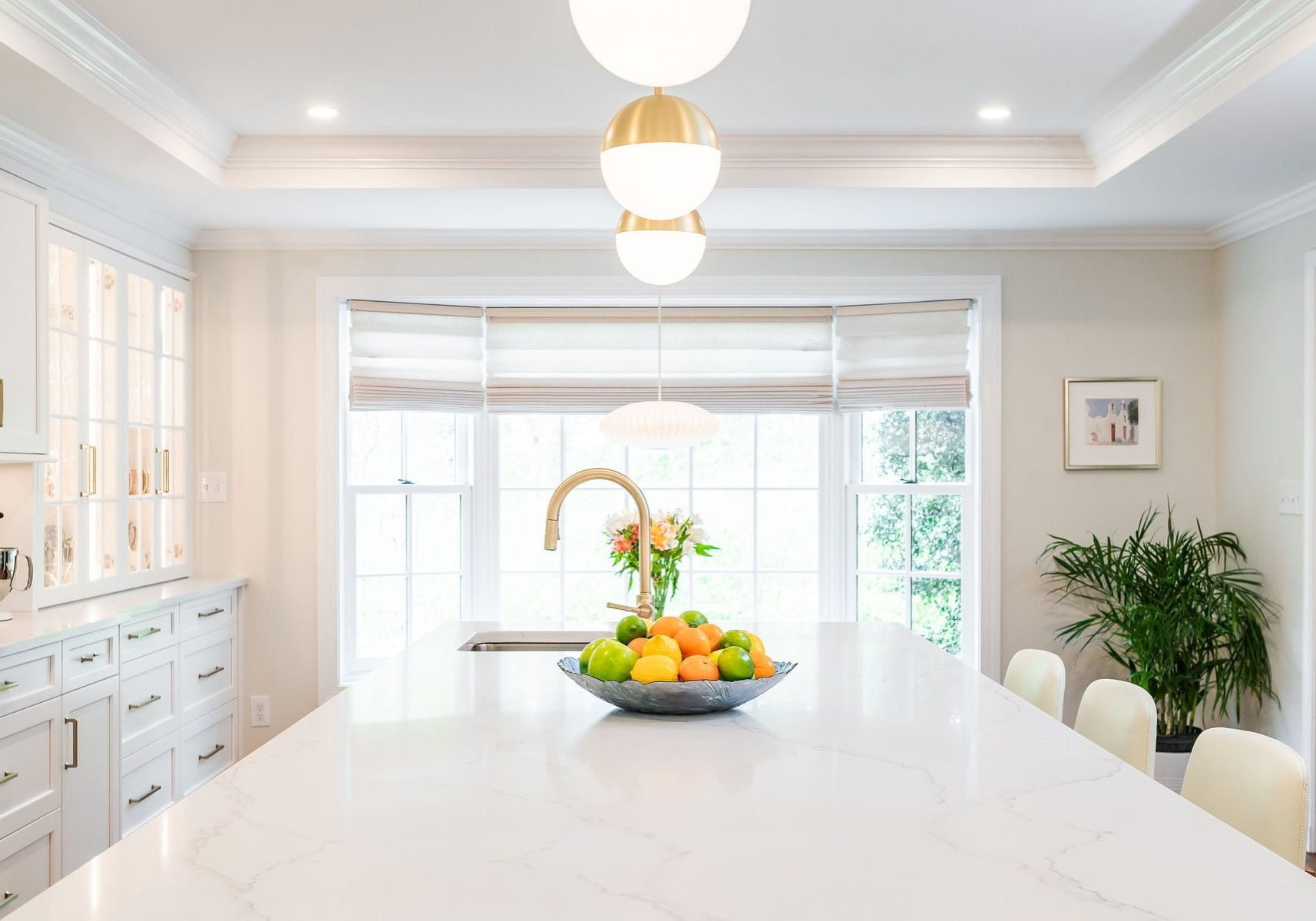 Transitional kitchen with stainless steel oven, white cabinetry, marble countertops (Different view)