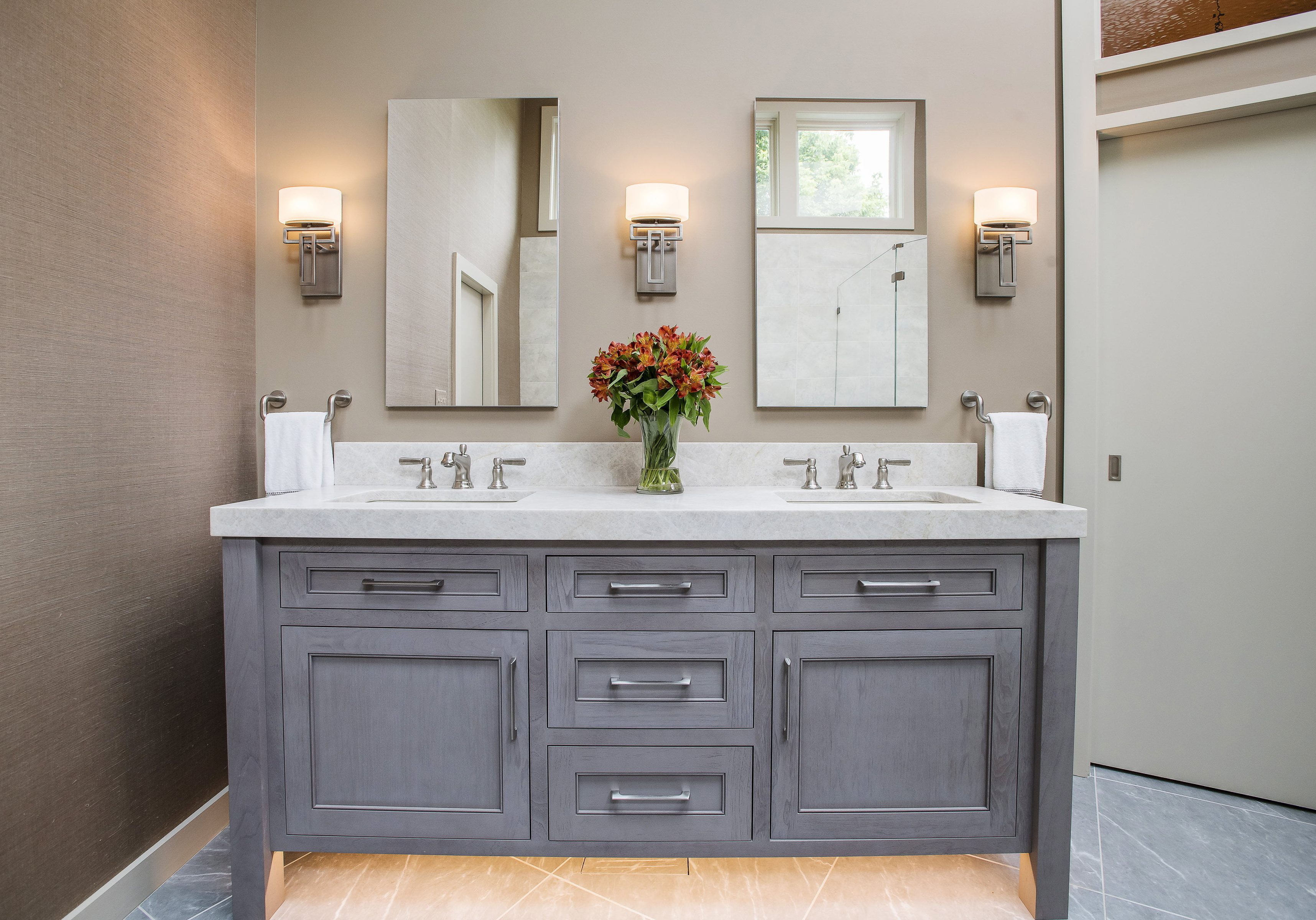 Modern bathroom with custom wooden bathtub, personal mirrors, and marble countertops (whole vanity)